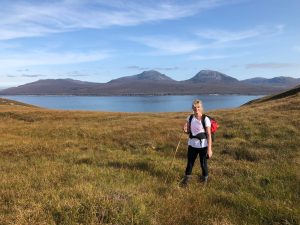 Girl hiking with sea in background