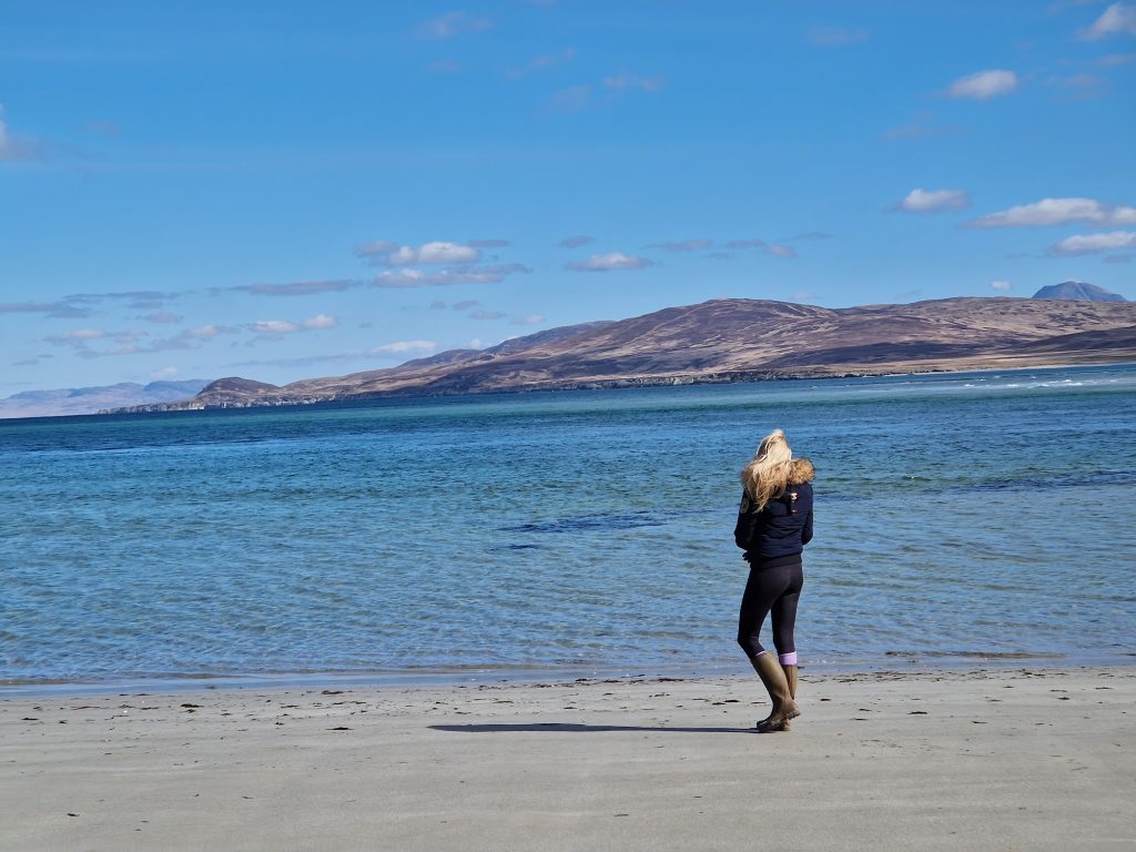 Girl walking on sandy beach