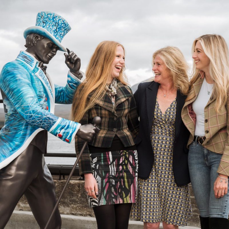 Striding Man Statue and 3 ladies