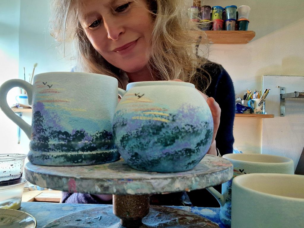 Lady painting pottery
