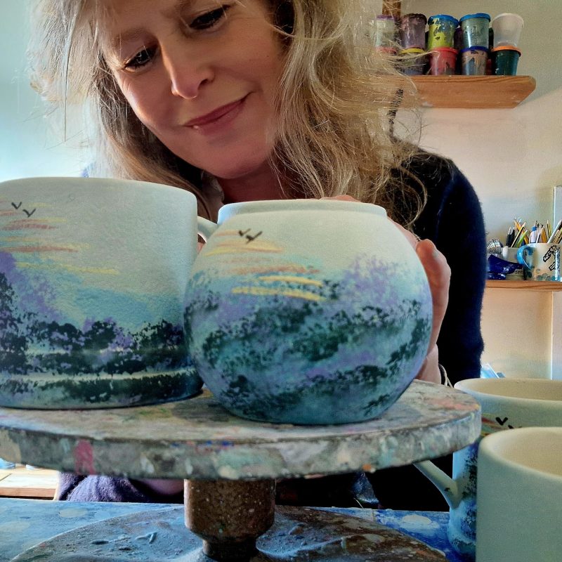 Lady painting pottery