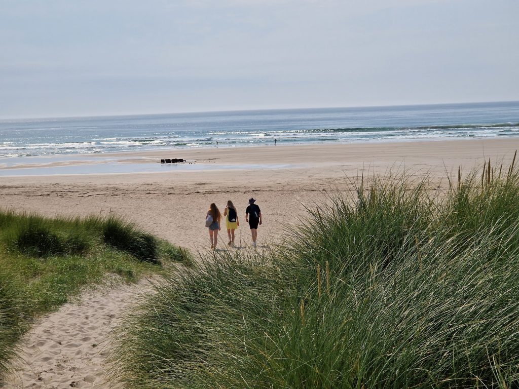 People walking onto beach