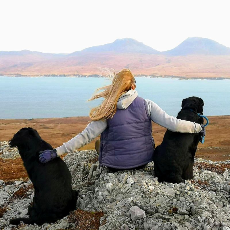 Girl sat with two dogs