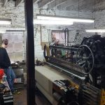 Person working a loom at Islay Woolllen Mill