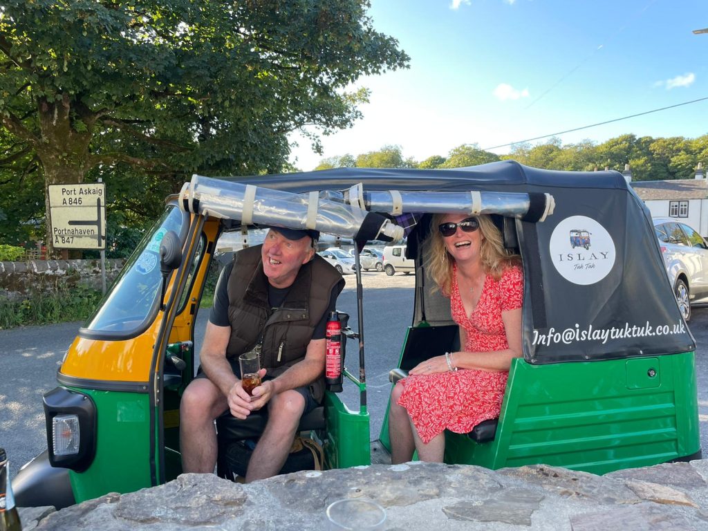 Two people in a Tuk Tuk