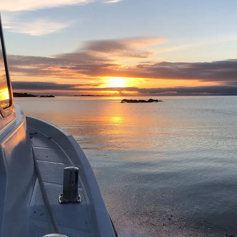 Boat on sea at sunset