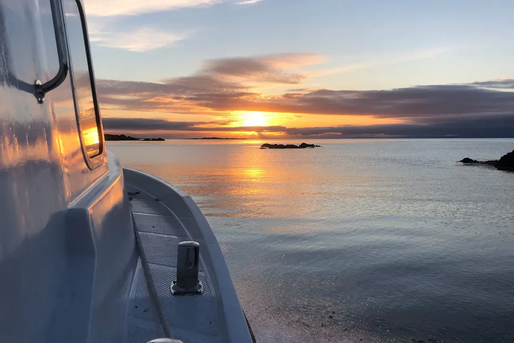 Boat on sea at sunset