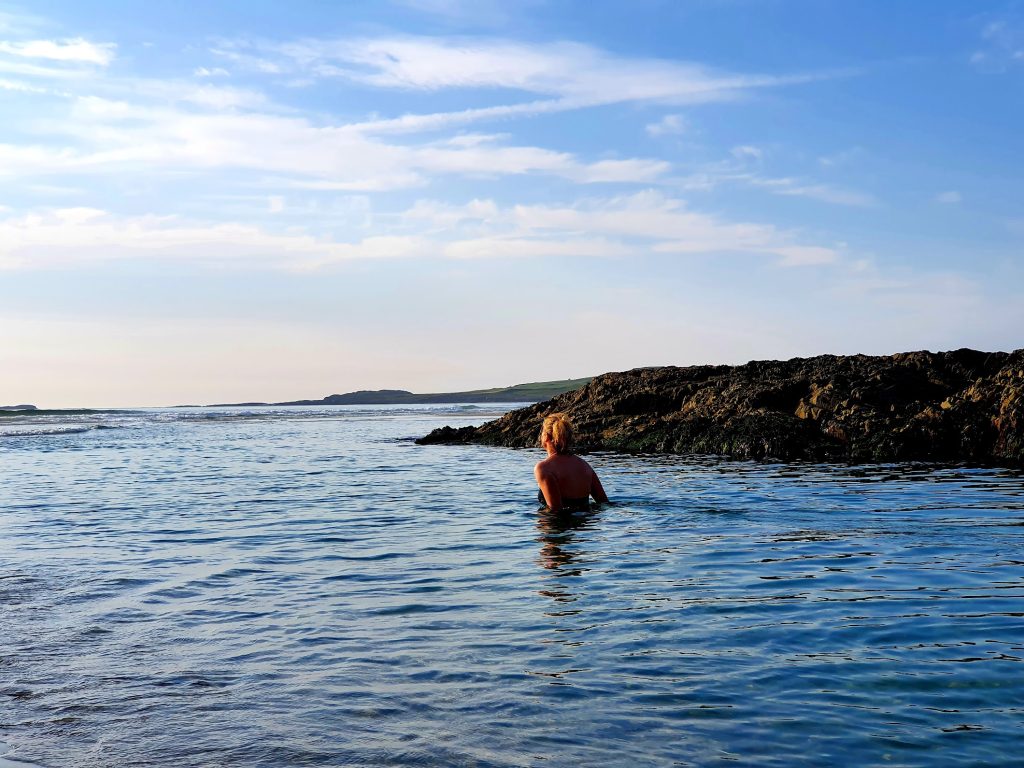 Back of lady standing in the sea