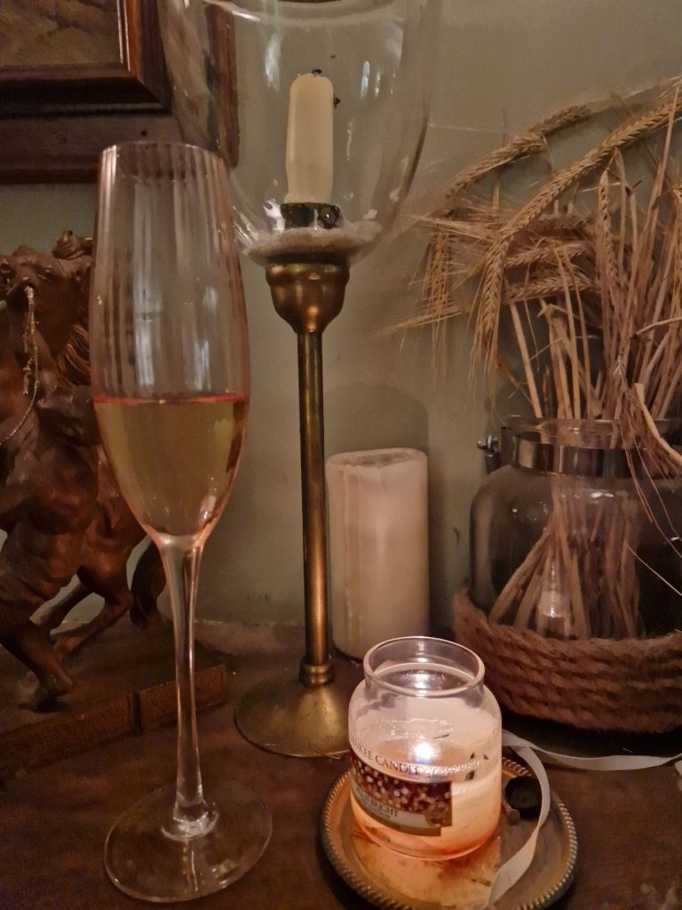A glass of fizz and a candle