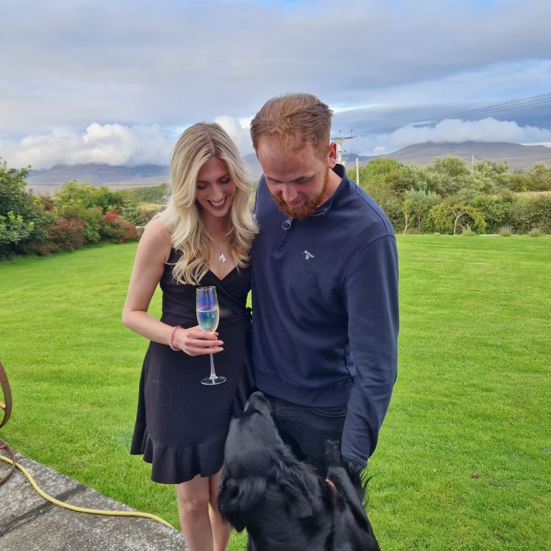 Couple stroking a dog