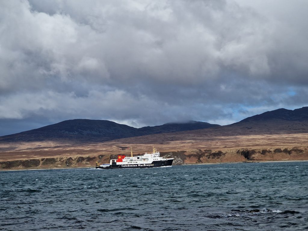 Ferry boat in sea with hills in background