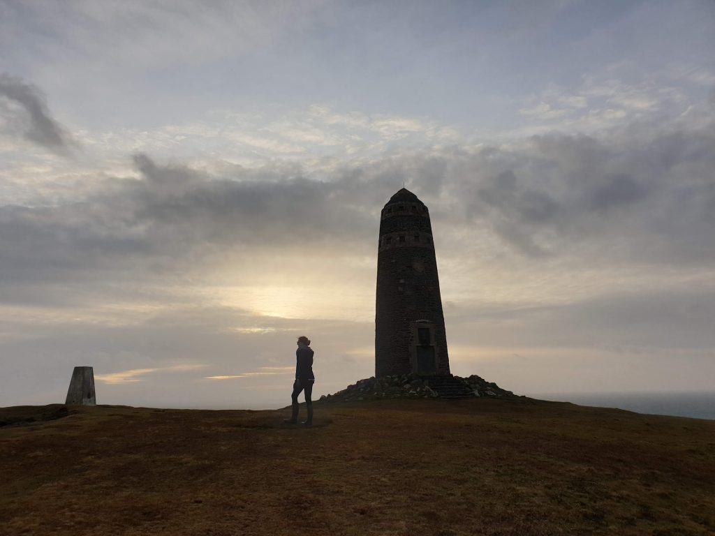 girl walking away from a large monument